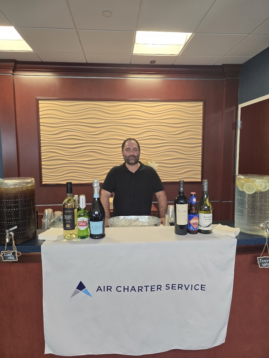 Bartender at a simple table bar setup.