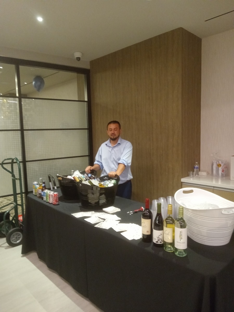 Bartender preparing an indoor event service station.
