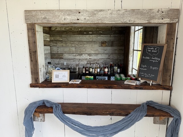 Rustic wedding bar with drinks of the night chalkboard and liquor bottles