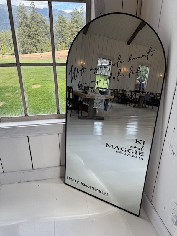 Wedding mirror with KJ and Maggie date overlooking Montana mountains