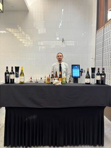 Bartender standing behind a prepared event bar.