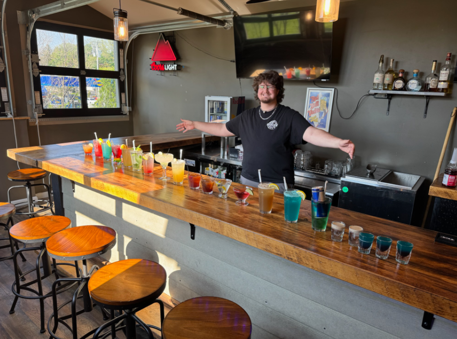 Indoor bar with bartender preparing a service station.